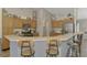 Well-equipped kitchen with granite countertops, bar seating, and stainless steel appliances at 3021 Toluca Ter, North Port, FL 34286