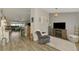 Cozy living room features a recliner, wood floors, and an open floor plan at 3021 Toluca Ter, North Port, FL 34286