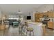 Open-concept living area with kitchen, bar seating, and comfortable gray sofa at 3021 Toluca Ter, North Port, FL 34286