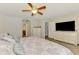 Bright primary bedroom with Queen bed, ceiling fan, and convenient access to en-suite bathroom at 3021 Toluca Ter, North Port, FL 34286