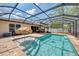 A beautiful private screened-in pool with patio and a sun umbrella for shade and relaxation at 3021 Toluca Ter, North Port, FL 34286