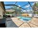 Backyard pool with screened enclosure, patio, and landscaping at 3021 Toluca Ter, North Port, FL 34286