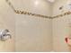 Close up on shower with tile surround and decorative tile trim at 3021 Toluca Ter, North Port, FL 34286