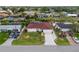 Aerial view of the house featuring a well-maintained lawn, landscaping, and long driveway at 3301 Santa Barbara Dr, Punta Gorda, FL 33983