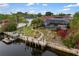Backyard view with screened pool, tropical landscaping, and waterfront dock offering a private, outdoor retreat at 3301 Santa Barbara Dr, Punta Gorda, FL 33983