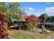 Backyard scene with storage for kayaks and lawn chairs, featuring lush landscaping and waterfront access at 3301 Santa Barbara Dr, Punta Gorda, FL 33983