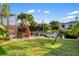 Backyard featuring a hammock, dock, canal, and tropical foliage at 3301 Santa Barbara Dr, Punta Gorda, FL 33983