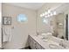 Bright bathroom featuring double sinks, octagon window, and classic fixtures at 3301 Santa Barbara Dr, Punta Gorda, FL 33983