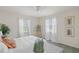 Bright bedroom with two windows, ceiling fan, and white bedding at 3301 Santa Barbara Dr, Punta Gorda, FL 33983