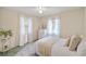 Bright bedroom featuring two windows, white furniture, and tiled floors at 3301 Santa Barbara Dr, Punta Gorda, FL 33983
