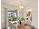 Dining area featuring access to screened patio and views of the pool and backyard at 3301 Santa Barbara Dr, Punta Gorda, FL 33983