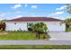 Inviting single-story home featuring an attached garage, tidy landscaping, and a red tile roof at 3301 Santa Barbara Dr, Punta Gorda, FL 33983