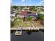 Exterior shot showing backyard with screened pool, dock, and lush landscaping, perfect for outdoor enjoyment at 3301 Santa Barbara Dr, Punta Gorda, FL 33983