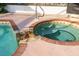 Inviting hot tub with brick trim, rock detail, and clear, sparkling water at 3301 Santa Barbara Dr, Punta Gorda, FL 33983
