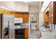 Kitchen featuring stainless steel refrigerator, wood cabinets, and a view to the dining room at 3301 Santa Barbara Dr, Punta Gorda, FL 33983