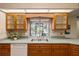 Kitchen area featuring wood cabinets, stainless steel sink, with a view of the pool at 3301 Santa Barbara Dr, Punta Gorda, FL 33983