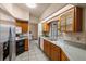 Bright kitchen featuring wood cabinets, stainless steel fridge, and a view to the outdoor patio at 3301 Santa Barbara Dr, Punta Gorda, FL 33983
