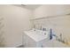 Laundry room featuring a washer, dryer, shelving, and utility sink at 3301 Santa Barbara Dr, Punta Gorda, FL 33983