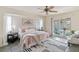 Serene main bedroom featuring a sliding door to the lanai, ceiling fan, and modern décor at 3301 Santa Barbara Dr, Punta Gorda, FL 33983