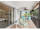 Covered patio with fan, table, chairs, and sliding glass doors at 3301 Santa Barbara Dr, Punta Gorda, FL 33983