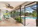 Inviting screened-in patio with fan, outdoor furniture, and beautiful pool views at 3301 Santa Barbara Dr, Punta Gorda, FL 33983