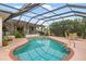 Beautiful, screened pool featuring a patio, hot tub, and lush landscaping at 3301 Santa Barbara Dr, Punta Gorda, FL 33983
