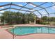 Relaxing screened-in pool featuring a spacious patio, seating, and lush landscaping at 3301 Santa Barbara Dr, Punta Gorda, FL 33983