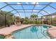 Inviting screened-in pool area with a patio, landscaping, and outdoor seating for relaxation at 3301 Santa Barbara Dr, Punta Gorda, FL 33983
