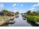 Inviting canal view showcasing boats and waterway access, enhancing waterfront living appeal under blue skies at 3301 Santa Barbara Dr, Punta Gorda, FL 33983