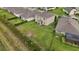 Aerial perspective of the property showcasing the expansive green yard, privacy landscaping and neighborhood at 3941 River Bank Way, Punta Gorda, FL 33980