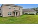 Back of the house with a covered patio overlooks a spacious yard and lovely landscaping for privacy at 3941 River Bank Way, Punta Gorda, FL 33980