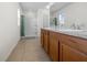 Bathroom with a double sink vanity and a walk-in shower at 3941 River Bank Way, Punta Gorda, FL 33980