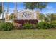 Attractive community sign with manicured landscaping and colorful flowers at 3941 River Bank Way, Punta Gorda, FL 33980