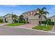 Charming two-story home with red shutters, a brick driveway, and a well-manicured lawn at 3941 River Bank Way, Punta Gorda, FL 33980