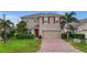Charming two-story home with red shutters, a brick driveway, and a well-manicured lawn at 3941 River Bank Way, Punta Gorda, FL 33980