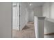 Well-lit hallway with neutral carpet, white trim, and multiple doors, showcasing the home's layout at 3941 River Bank Way, Punta Gorda, FL 33980