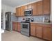 Kitchen with stainless steel appliances and wood cabinets offers an efficient cooking space at 3941 River Bank Way, Punta Gorda, FL 33980