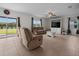 Comfortable living room with tile floors, a ceiling fan, and sliding doors to the outdoor space at 3941 River Bank Way, Punta Gorda, FL 33980
