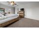 Carpeted main bedroom features a bed, dresser, and a ceiling fan at 3941 River Bank Way, Punta Gorda, FL 33980
