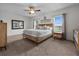Well-lit bedroom with a ceiling fan and views of the outside at 3941 River Bank Way, Punta Gorda, FL 33980