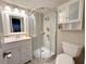 Updated bathroom featuring a glass-enclosed shower, vanity, and modern fixtures at 4158 Tamiami Trl # A5, Port Charlotte, FL 33952