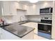 Bright kitchen features white cabinets, subway tile backsplash, and stainless steel appliances at 4158 Tamiami Trl # A5, Port Charlotte, FL 33952