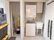 Efficient laundry area with stacked washer/dryer and utility sink, maximizing space and convenience at 4158 Tamiami Trl # A5, Port Charlotte, FL 33952