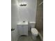 Cozy bathroom featuring a toilet and vanity sink with a tiled shower space at 514 Showalter Ave, Punta Gorda, FL 33950