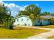 Charming single-story home featuring a well-maintained lawn, mature trees, and a welcoming exterior at 514 Showalter Ave, Punta Gorda, FL 33950