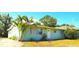 Inviting single-story home with a mature palm tree, green grass, and a freshly painted exterior at 514 Showalter Ave, Punta Gorda, FL 33950