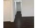 A spacious hallway leads to various rooms in the home, with dark floors for easy clean up at 514 Showalter Ave, Punta Gorda, FL 33950