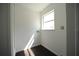 A bright laundry room with tile flooring, a large window, and washer and dryer hookups. Schedule your visit! at 514 Showalter Ave, Punta Gorda, FL 33950