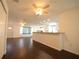Open-concept living space featuring dark floors, bright white walls, and a breakfast bar at 514 Showalter Ave, Punta Gorda, FL 33950
