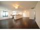Spacious open-concept living room featuring modern dark floors, white walls, and stylish ceiling fans at 514 Showalter Ave, Punta Gorda, FL 33950